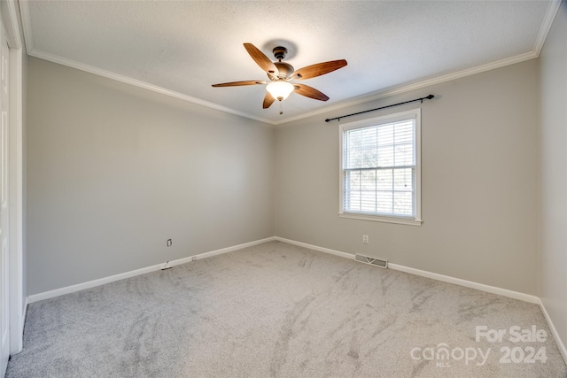 spare room with ornamental molding, light colored carpet, and ceiling fan