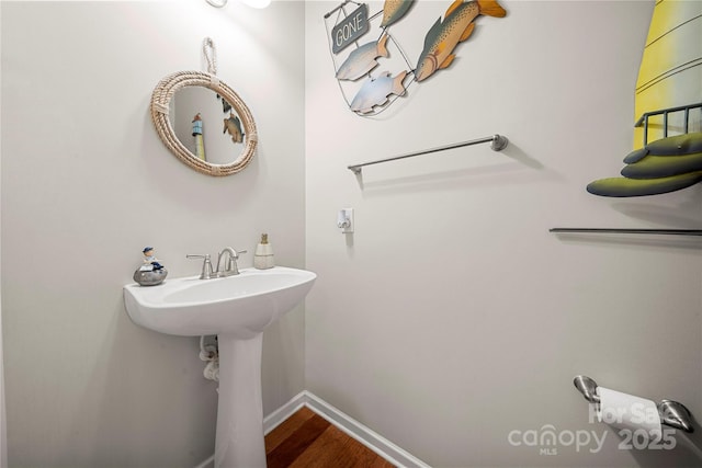 bathroom with baseboards and wood finished floors