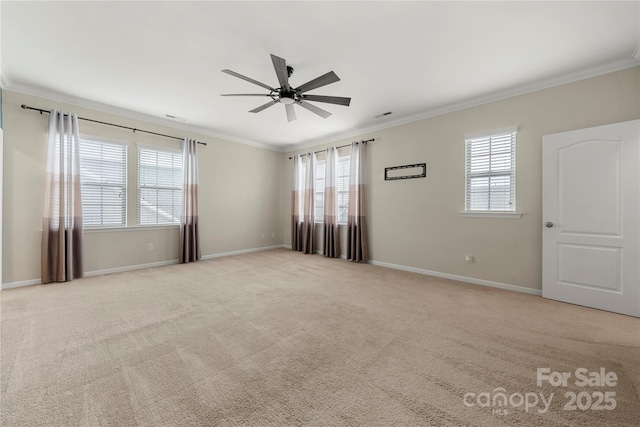 empty room featuring ornamental molding, carpet flooring, and baseboards