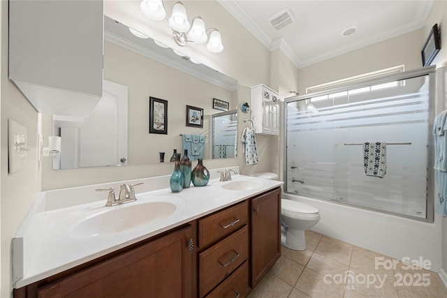 bathroom featuring crown molding, a sink, toilet, and tile patterned floors