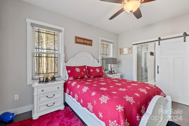 bedroom with a barn door and ceiling fan