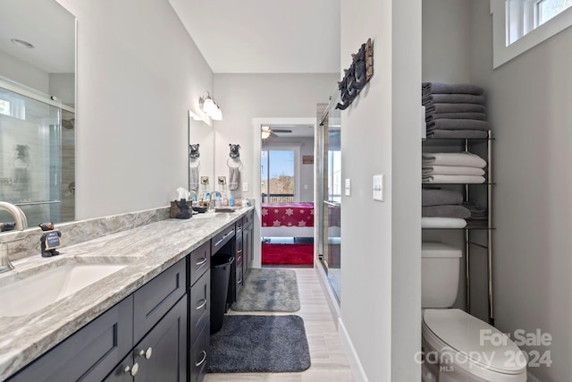 bathroom with vanity, toilet, a shower with shower door, and wood-type flooring