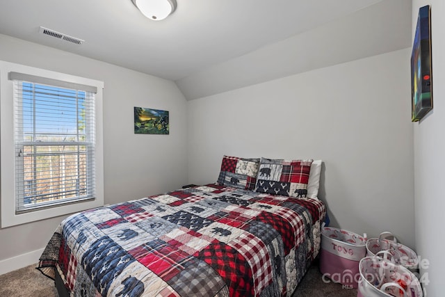 bedroom featuring carpet, multiple windows, and lofted ceiling