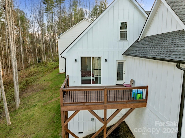 wooden terrace featuring a yard