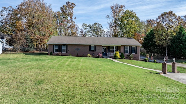 single story home featuring a front lawn