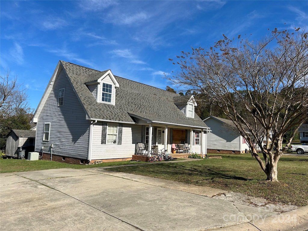 cape cod house featuring covered porch and a front yard