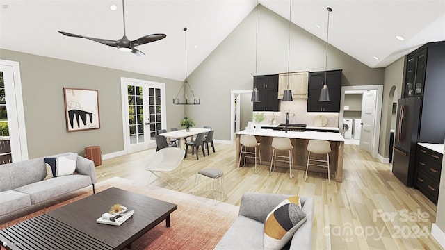 living room with french doors, separate washer and dryer, light wood-type flooring, high vaulted ceiling, and ceiling fan