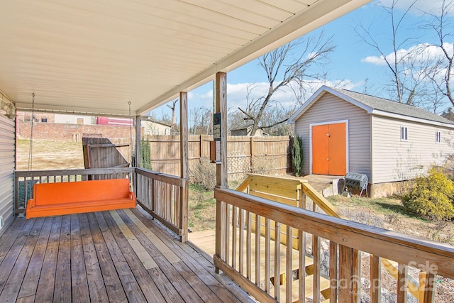 wooden terrace with a storage shed