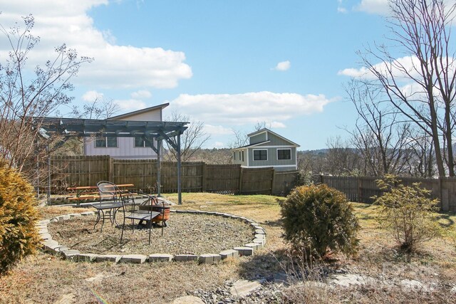 view of yard with a fire pit