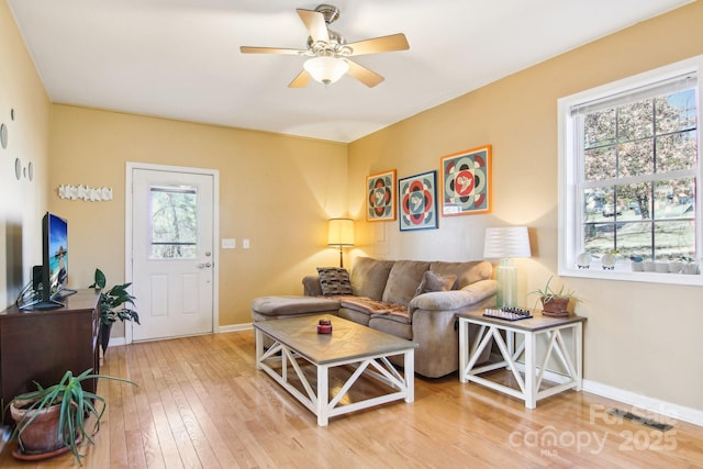 living room featuring ceiling fan and wood-type flooring