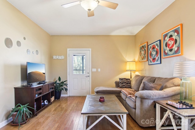 living room featuring ceiling fan and light hardwood / wood-style floors