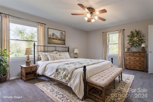 bedroom with ceiling fan and dark carpet