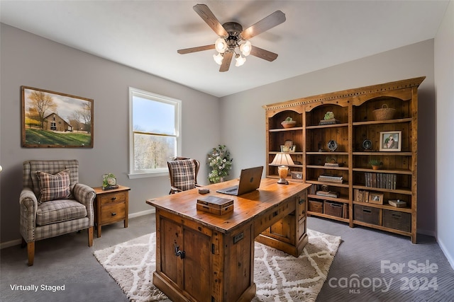 carpeted office space with ceiling fan