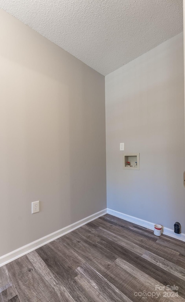 laundry room featuring hookup for a washing machine, dark hardwood / wood-style flooring, and a textured ceiling