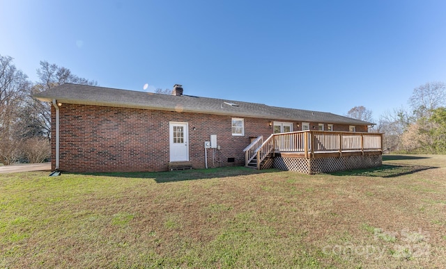 back of property with a lawn and a wooden deck