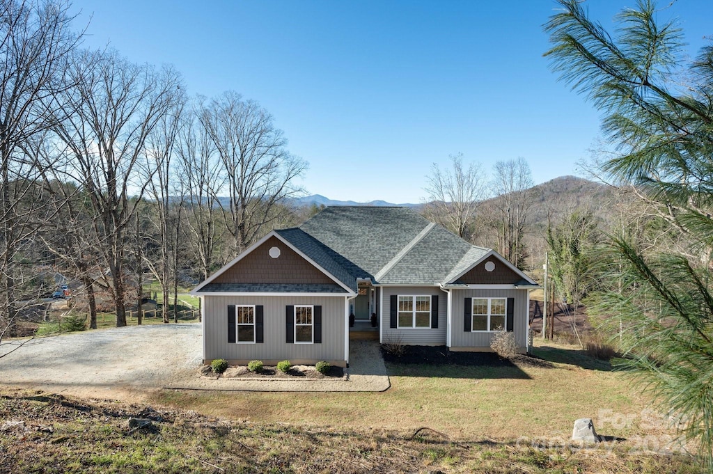 view of front of house with a mountain view and a front yard