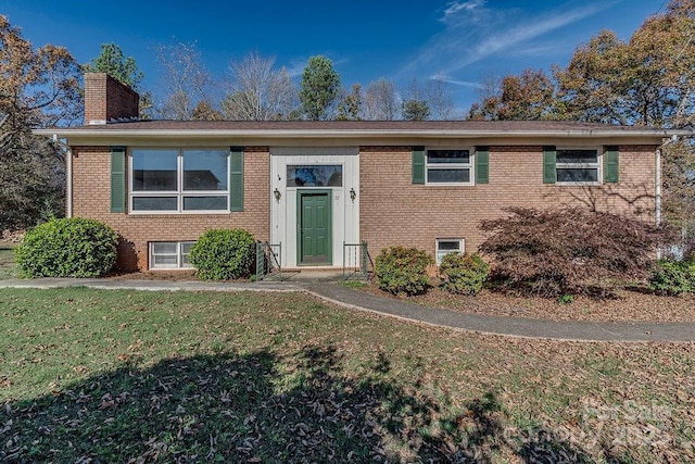 raised ranch featuring a front lawn