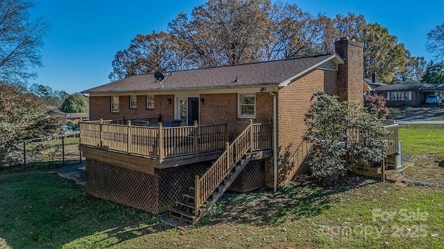 back of house with a yard and a deck