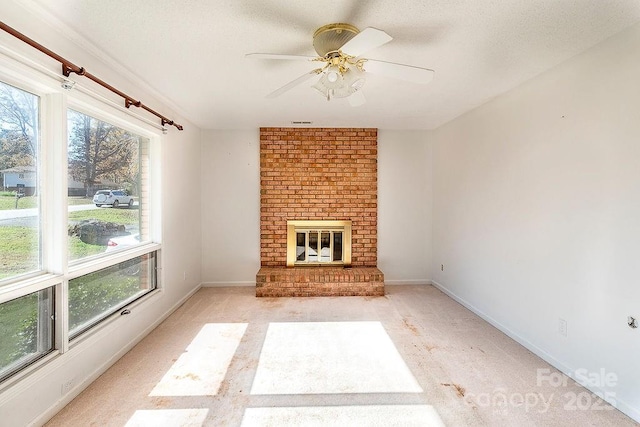 unfurnished living room with ceiling fan and a fireplace