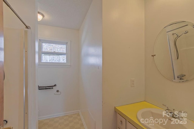 bathroom with vanity and a textured ceiling