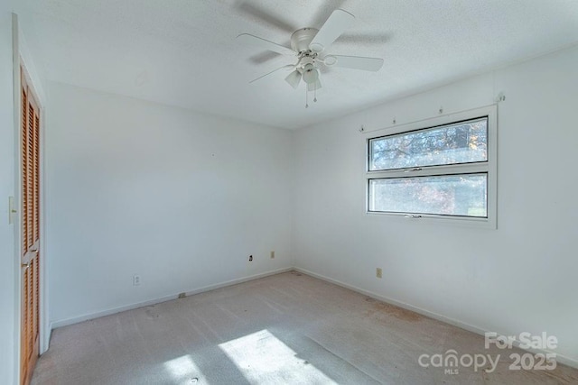 unfurnished bedroom featuring light colored carpet, ceiling fan, and a closet