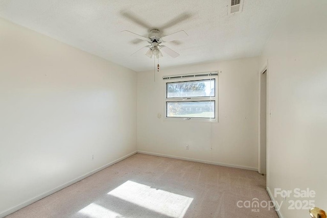 unfurnished room with light colored carpet and ceiling fan