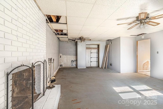 interior space with ceiling fan and a fireplace