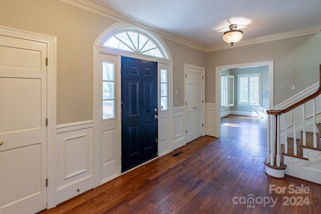 foyer featuring dark hardwood / wood-style floors and crown molding