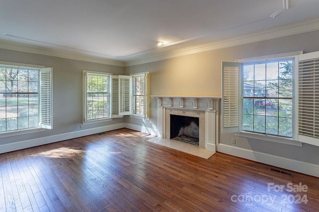 unfurnished living room featuring hardwood / wood-style floors, plenty of natural light, and crown molding