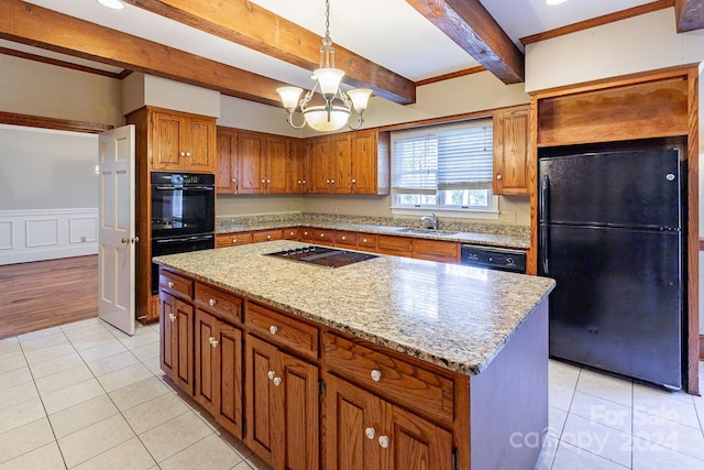 kitchen featuring black appliances, light tile patterned floors, beamed ceiling, a center island, and a chandelier