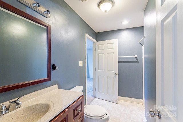 bathroom featuring vanity and toilet