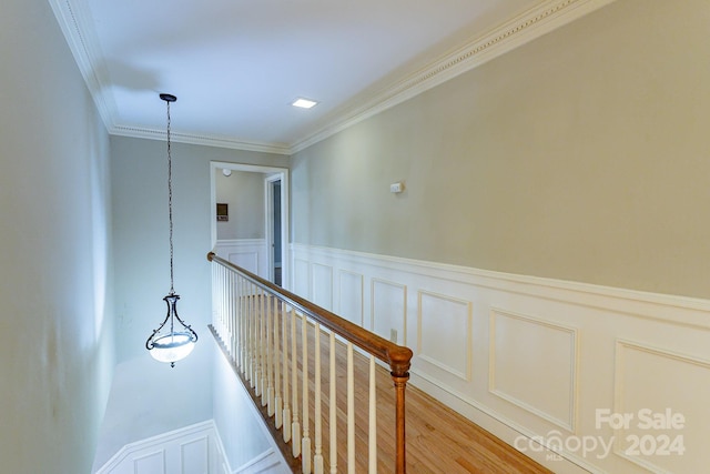 hall featuring crown molding and light hardwood / wood-style flooring