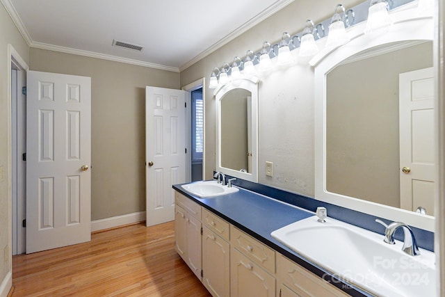 bathroom featuring vanity, hardwood / wood-style flooring, and crown molding