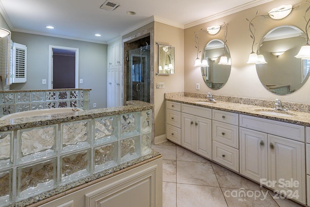 bathroom with vanity, tile patterned floors, a shower with door, and ornamental molding