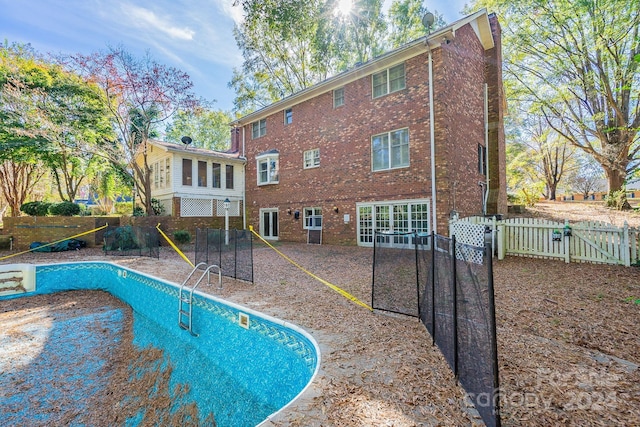 view of pool featuring a sunroom