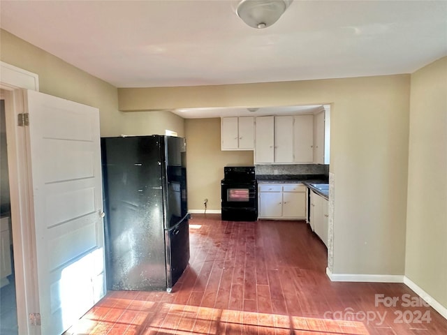 kitchen with black appliances, white cabinets, and wood-type flooring