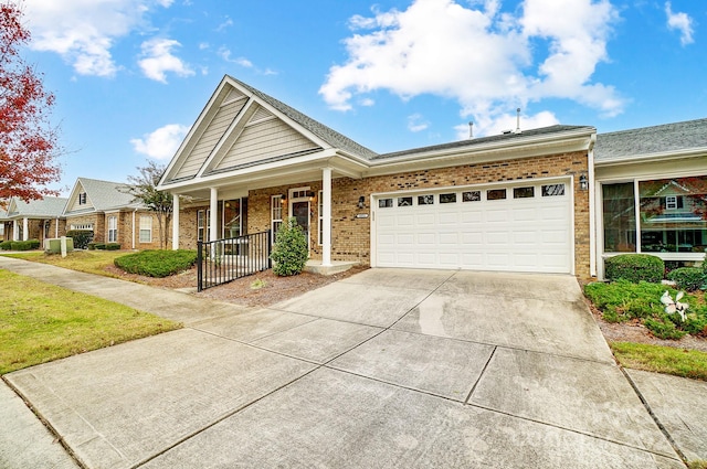 view of front of property featuring covered porch and a garage