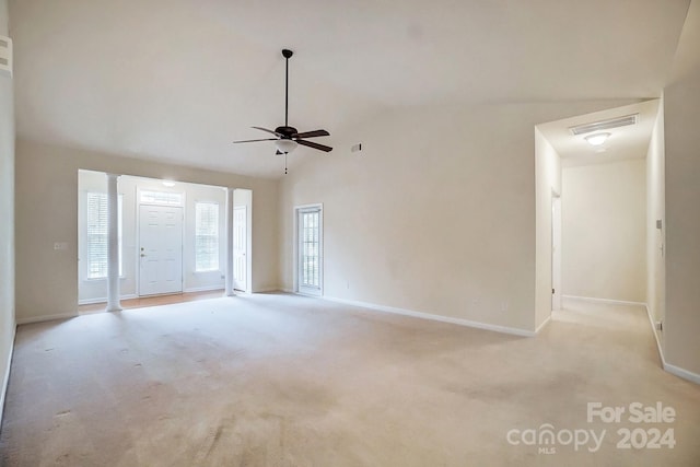 empty room with light carpet, ceiling fan, and high vaulted ceiling