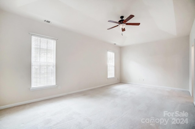 carpeted empty room featuring ceiling fan