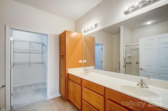 bathroom with tile patterned flooring, vanity, toilet, and an enclosed shower