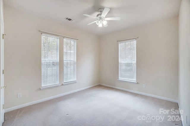 carpeted empty room with ceiling fan