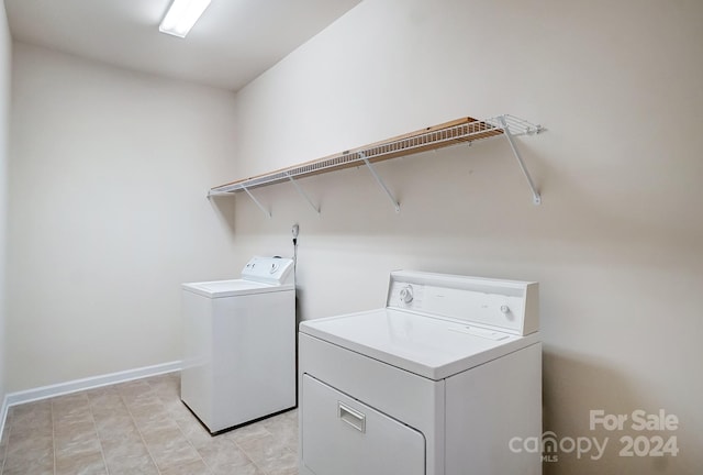 washroom with washing machine and clothes dryer