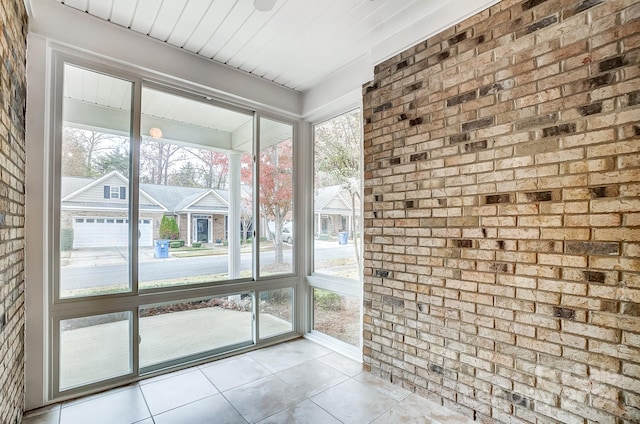 unfurnished sunroom featuring plenty of natural light