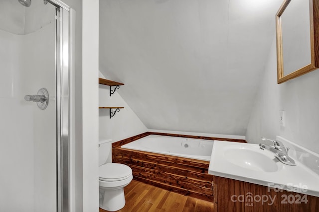 full bathroom featuring vaulted ceiling, shower with separate bathtub, toilet, vanity, and hardwood / wood-style flooring