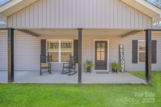 exterior space with board and batten siding and a lawn