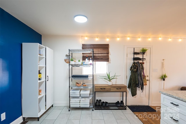 kitchen with white cabinets, rail lighting, and light tile patterned flooring