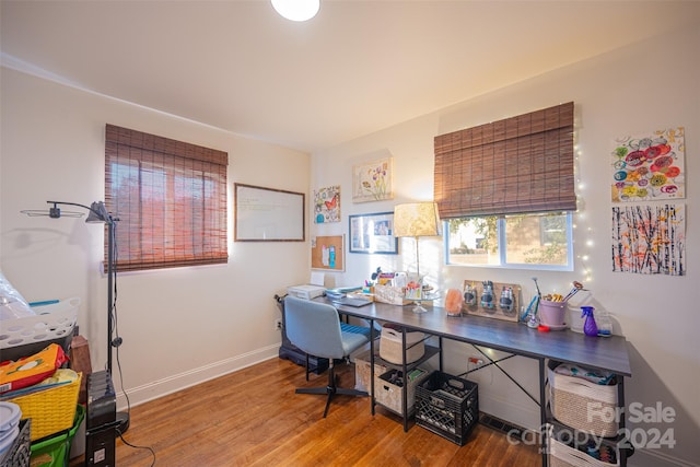 office space with wood-type flooring