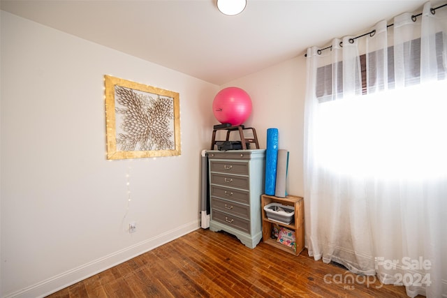 bedroom with dark hardwood / wood-style floors