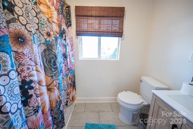 bathroom with curtained shower, tile patterned flooring, vanity, and toilet