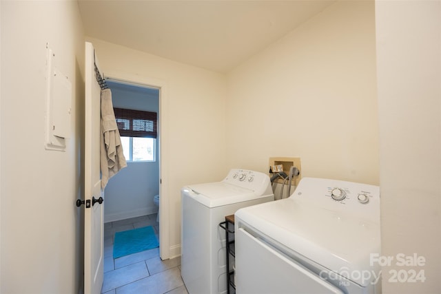 laundry area with light tile patterned floors and washer and clothes dryer